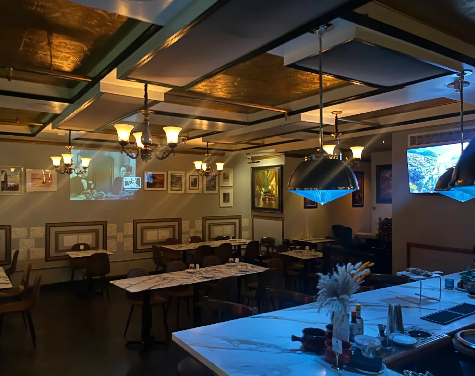 The dining room at The Bar & Bean Fusion, lit by chandeliers